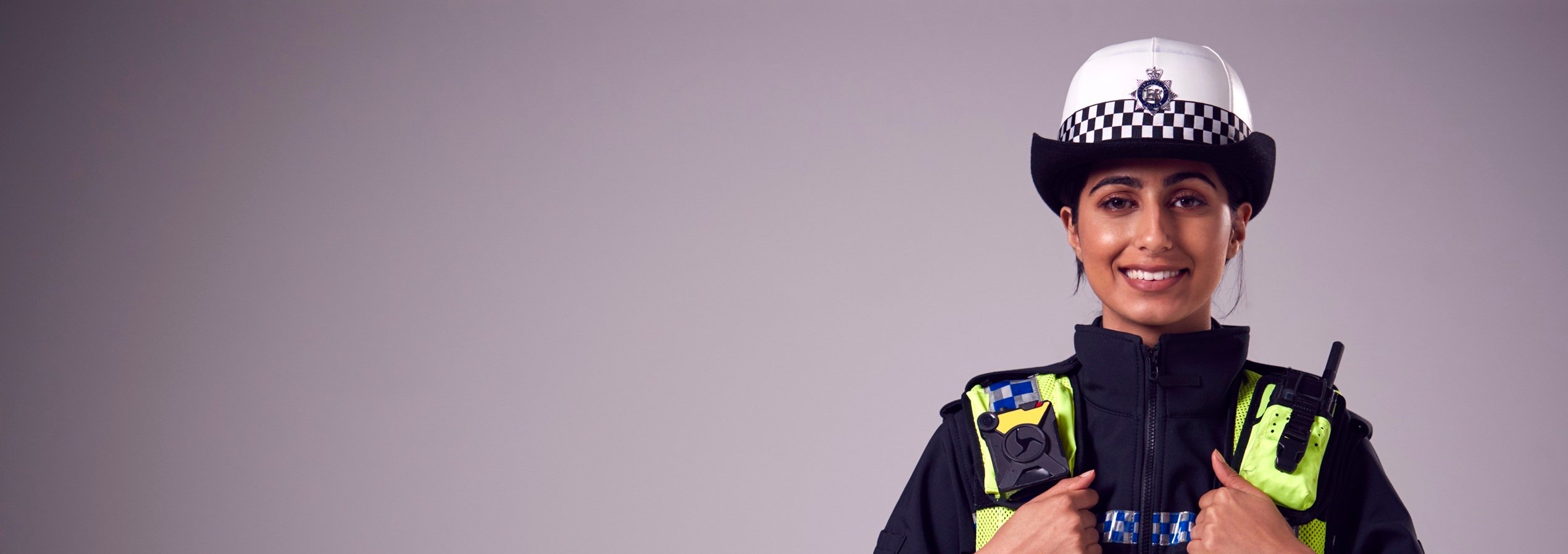 studio-portrait-of-smiling-young-female-police-off